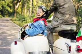 Smiling senior woman in a sidecar