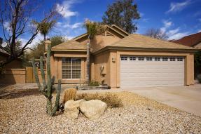 Southwestern home with cactus and blue sky