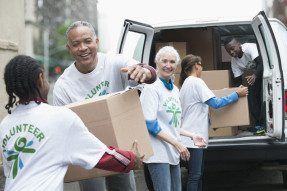 Volunteers loading boxes into a van