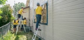 Volunteers painting a house