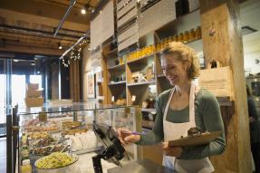 Woman at the register in a coffeeshop bakery
