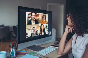 Woman talking with group of people during a video conference