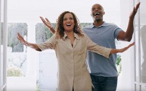Black couple walking into a home
