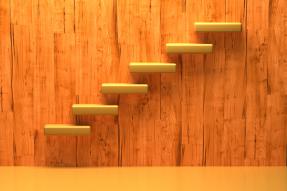 Yellow floating steps on a wooden wall