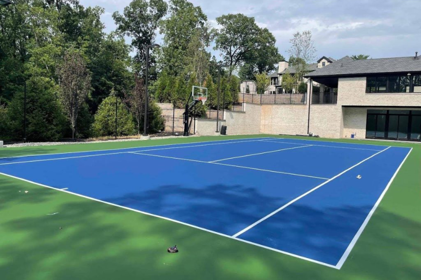 A backyard basketball and tennis court