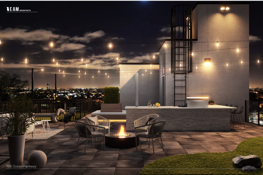 Nighttime view of an outdoor deck with seating and firepits on a deck at a multifamily property