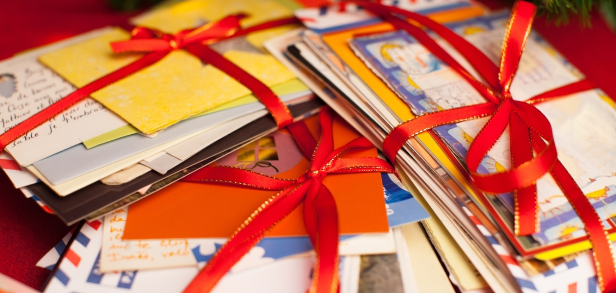 Stacks of letters and cards wrapped in red ribbon