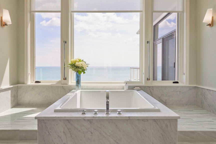 View of modern, rectangular tub overlooking a waterfront view