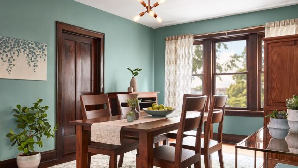 green dining room with wood trim
