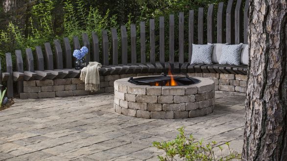 stone backyard fire pit with seating area