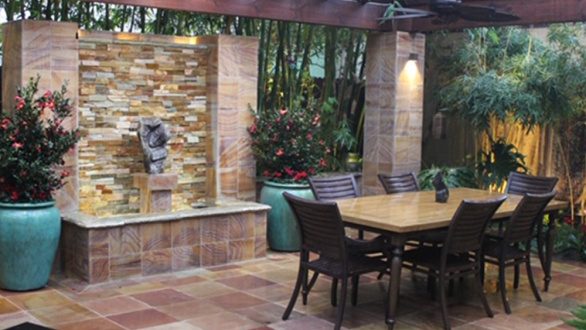 patio space with dining area and water feature