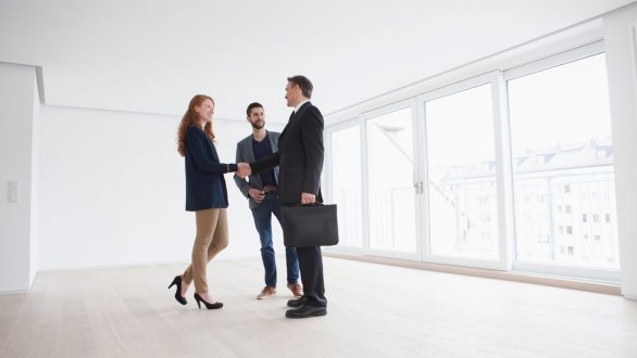 Real estate agent with couple in condo
