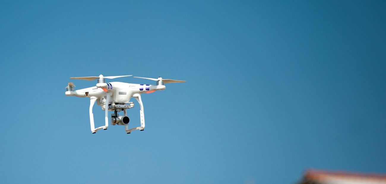 drone flies over rooftops 