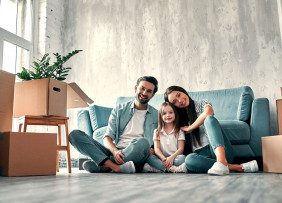 Family in New Home With Boxes