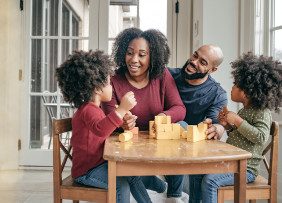 African American family playing at kids' table