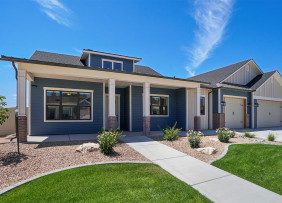 Blue-gray house with lawn and gravel landscaping