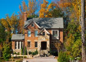 Brick house in wooded lot in autumn
