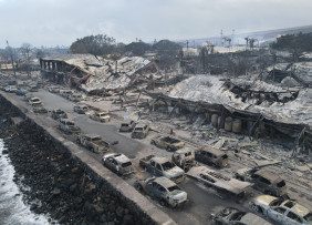 Burned cars and buildings near shoreline on Maui