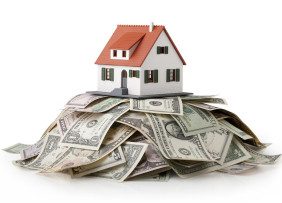 House model sitting on top of a money pile