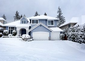 Large blue-gray house in the snow