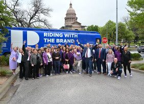RWTB - 2023 REALTOR® Day, Austin, TX, Group Shot of REALTORS® Posing in Front of the RWTB Bus