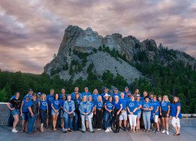 South Dakota REALTORS® pose with Mount Rushmore in the background in Sturgis, SD.