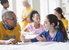 Volunteers tutoring school children
