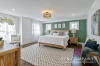 Bedroom with green accent wall staged by Patti Stern