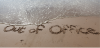 The words "out of office" written in sand at the beach