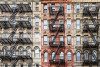 Brick apartment buildings with fire escapes