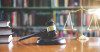 Gavel, scales, and books on a table