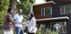Real estate agent greeting Black couple at house