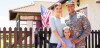 Military family standing in front of home