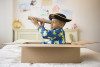 Little boy playing pirate in a moving box