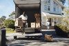 Man unloading cardboard box from van