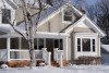 Two-Story Beige Midwestern Suburban House in Snow