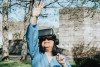 A woman wearing virtual reality headset in a park