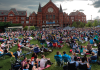 The renovated Washington Park in Cincinnati, Ohio, packed with attendees lining the lawn during an outdoor performance.