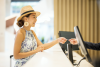 Women traveler, paying with a credit card at the front desk of a hotel