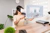 Woman wearing VR headset seeing 3-D floorplans