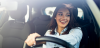 Young professional woman driving in a car